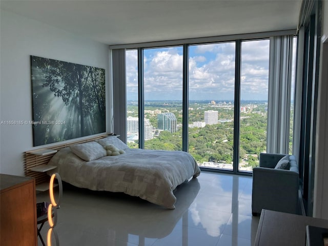 tiled bedroom featuring expansive windows and multiple windows