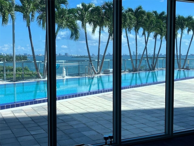 view of pool with a water view