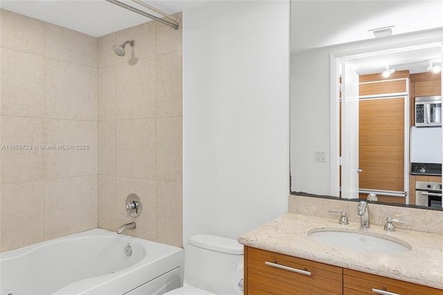 full bathroom with vanity, toilet, and tiled shower / bath combo