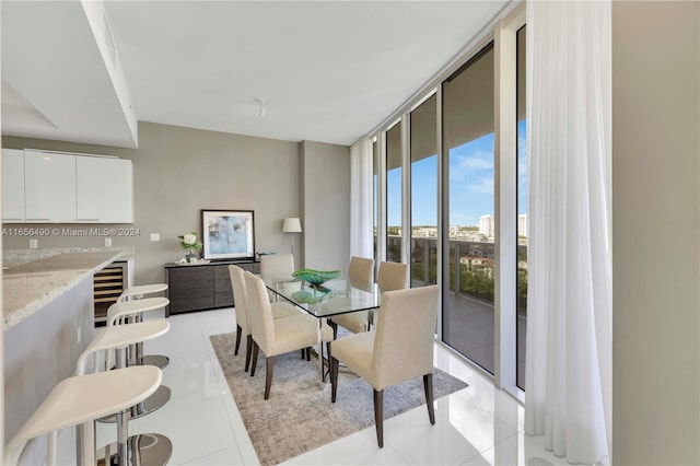 tiled dining room with floor to ceiling windows