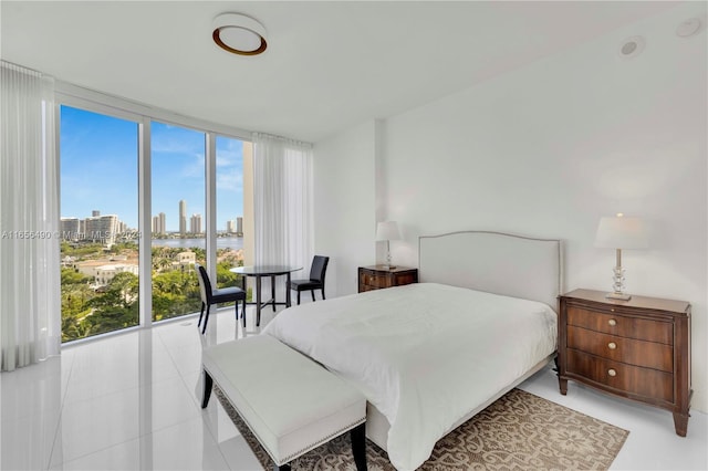 tiled bedroom with floor to ceiling windows and multiple windows