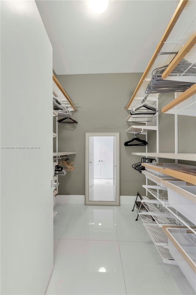 spacious closet with tile patterned floors