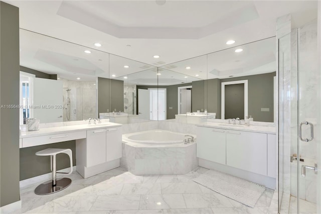 bathroom featuring a tray ceiling, vanity, and independent shower and bath