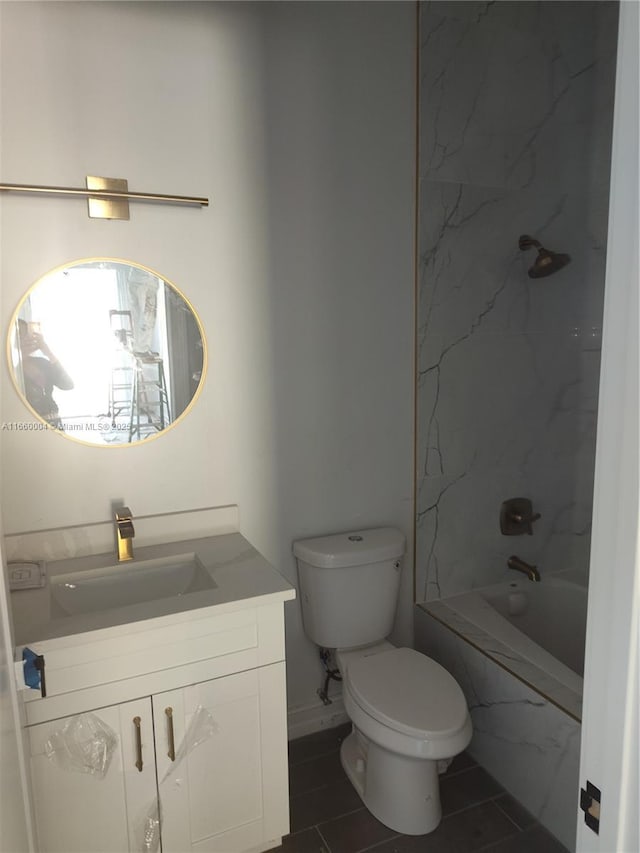 full bathroom featuring toilet, tiled shower / bath, and vanity