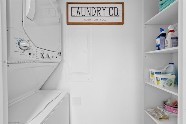 clothes washing area with stacked washer / dryer