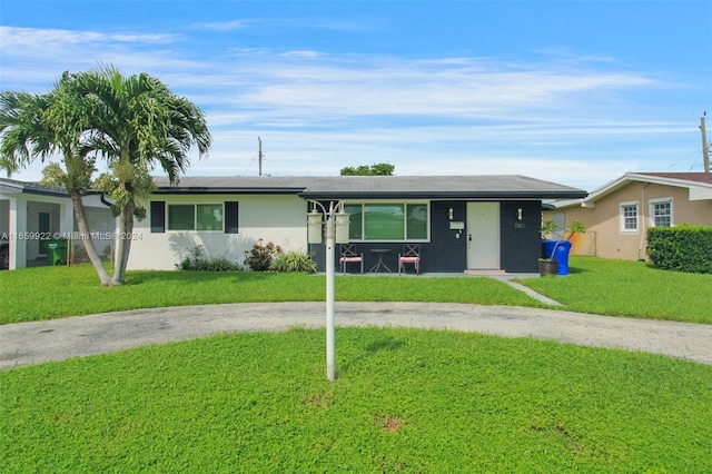 ranch-style home with a front lawn