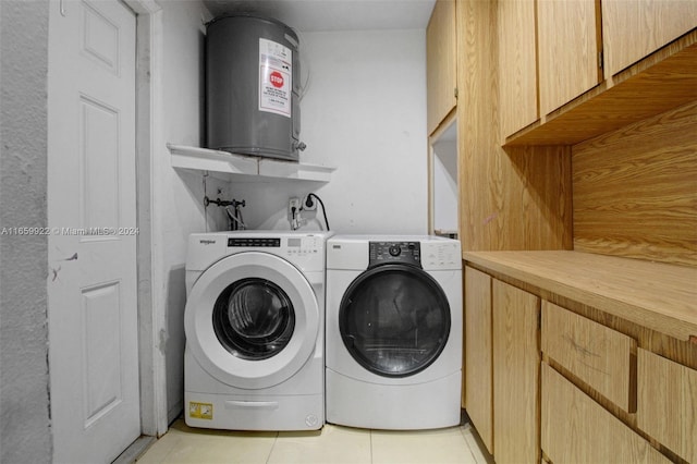 laundry room with washing machine and clothes dryer, light tile patterned floors, and water heater