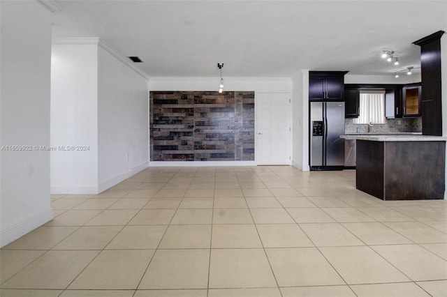 kitchen with ornamental molding, stainless steel fridge, tasteful backsplash, and light tile patterned floors