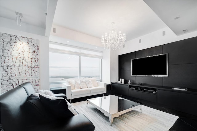 living room with light hardwood / wood-style floors and a chandelier