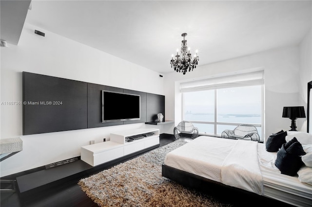 bedroom with a notable chandelier and wood-type flooring