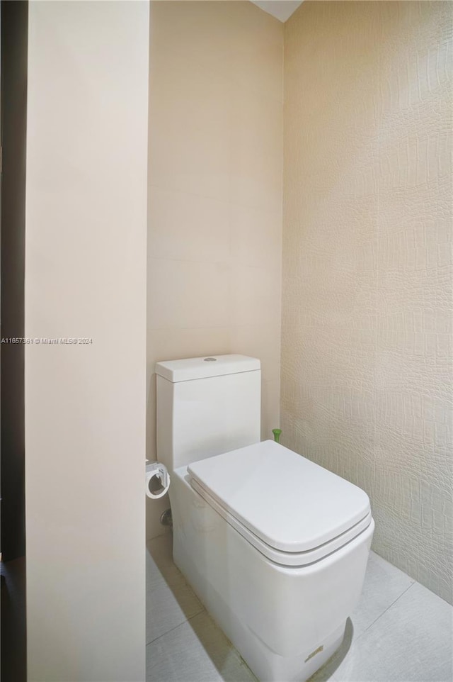 bathroom featuring tile patterned floors and toilet