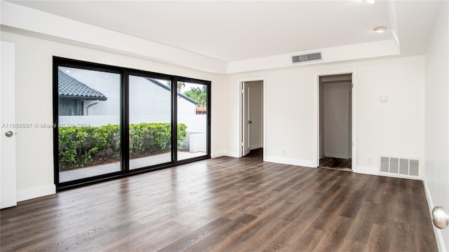 spare room with dark hardwood / wood-style floors