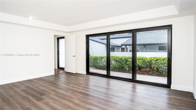 empty room featuring baseboards and wood finished floors