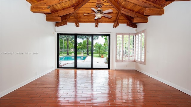 unfurnished room with wooden ceiling, baseboards, brick floor, ceiling fan, and vaulted ceiling with beams