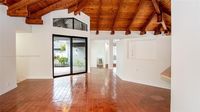spare room with high vaulted ceiling, beamed ceiling, baseboards, brick floor, and wooden ceiling