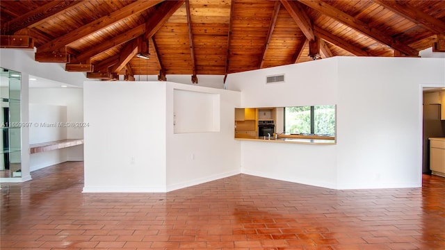 unfurnished living room featuring high vaulted ceiling, brick floor, visible vents, baseboards, and beamed ceiling