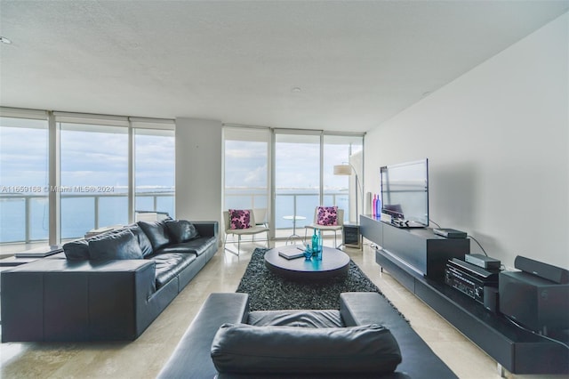 living room featuring a wall of windows and a textured ceiling