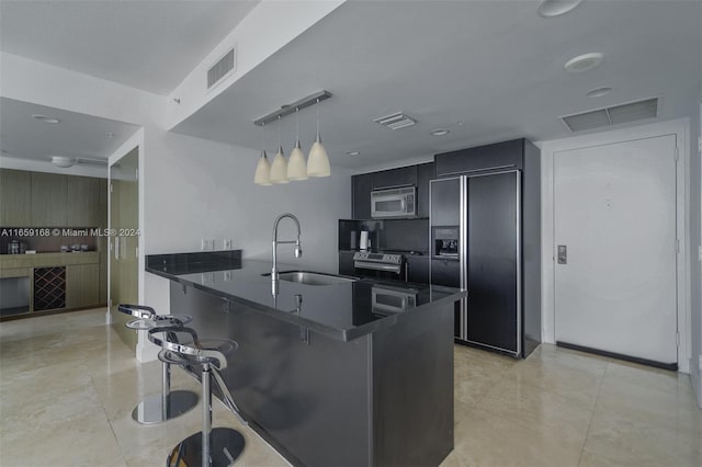 665 NE 25th St Unit 1704, Miami, FL 33137 - kitchen with high end black fridge, stainless steel microwave, dark countertops, a peninsula, and a breakfast bar