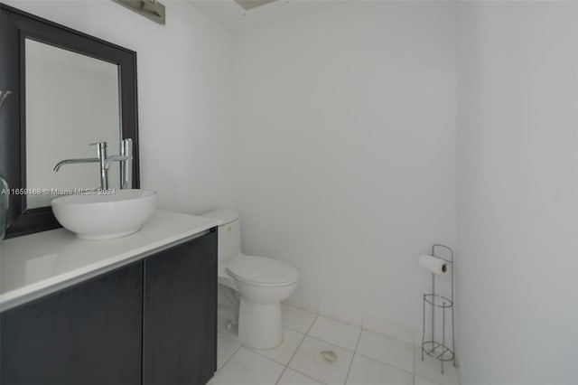 bathroom featuring vanity, toilet, and tile patterned floors