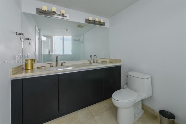 bathroom featuring tile patterned flooring, vanity, toilet, and a shower