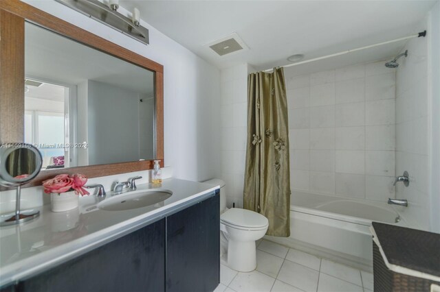 full bathroom with vanity, toilet, tile patterned floors, and shower / bathtub combination with curtain