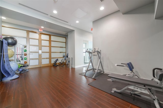 exercise area with dark hardwood / wood-style flooring and french doors