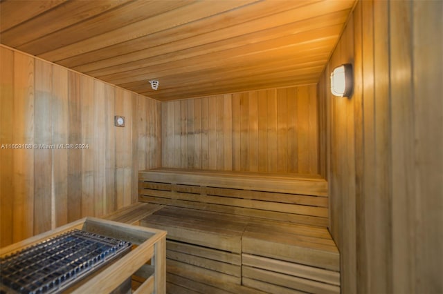 view of sauna featuring wooden walls and wooden ceiling