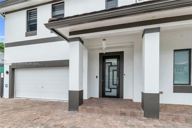 doorway to property with a garage