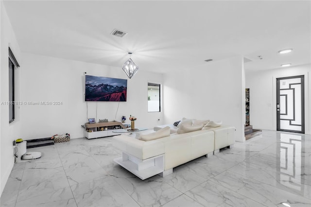 living room featuring a notable chandelier