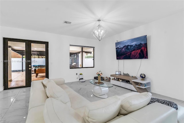 interior space featuring a notable chandelier and french doors