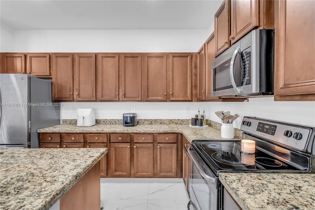 kitchen with light stone counters and stainless steel appliances