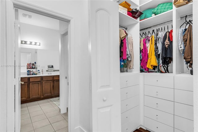 spacious closet featuring light tile patterned floors