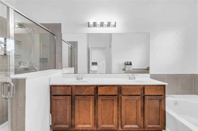 bathroom featuring vanity and separate shower and tub