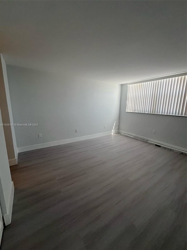 spare room with dark hardwood / wood-style floors