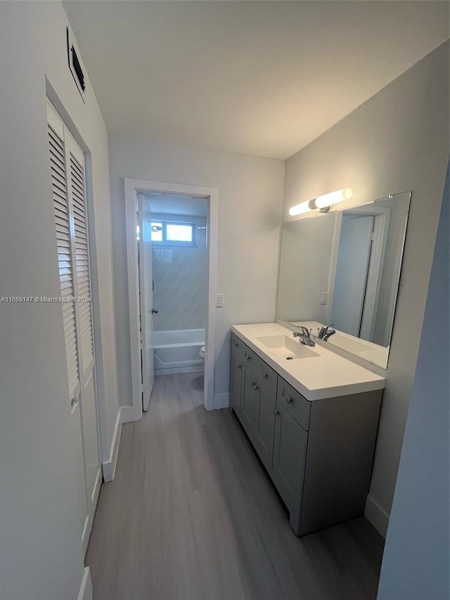 bathroom featuring hardwood / wood-style floors, vanity, and toilet