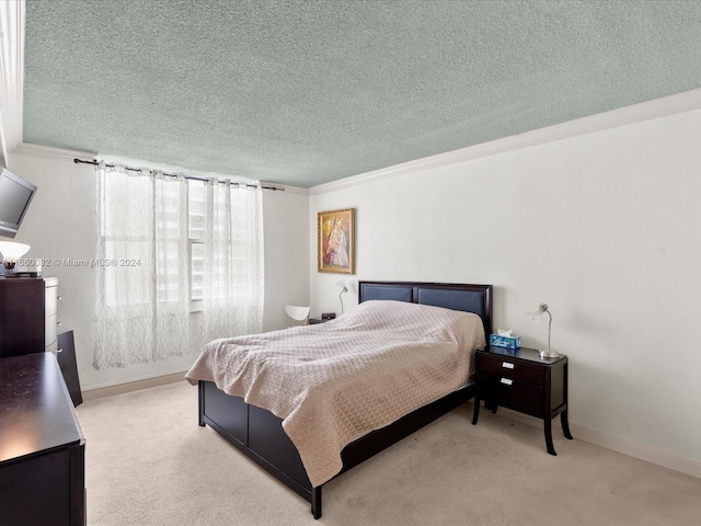 carpeted bedroom with a textured ceiling and crown molding