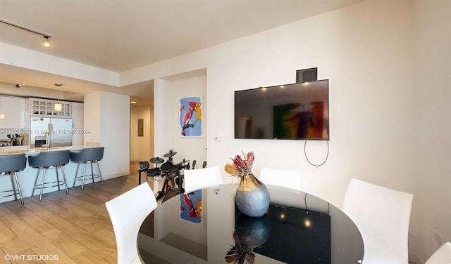 dining space with light hardwood / wood-style flooring