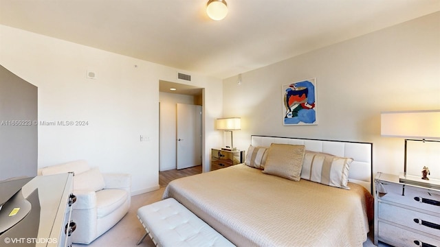 bedroom featuring light colored carpet