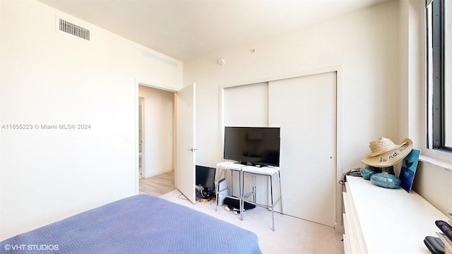 bedroom featuring light wood-type flooring and a closet