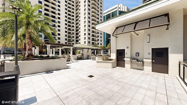 view of patio / terrace featuring area for grilling and a pergola