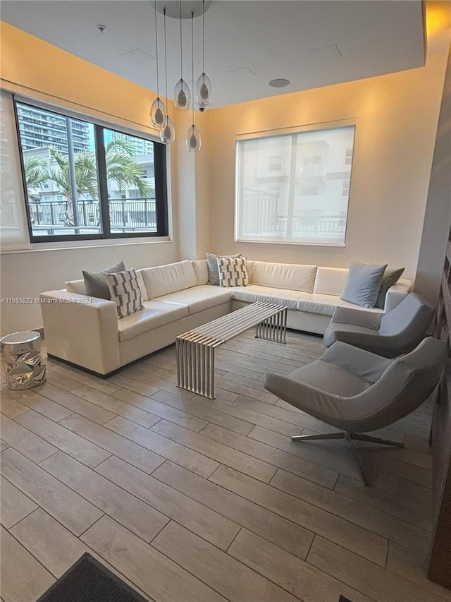 living room with an inviting chandelier and light hardwood / wood-style floors