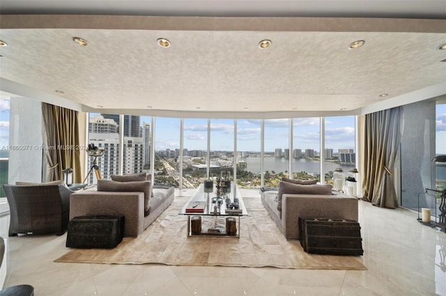 living room with a water view and a wall of windows