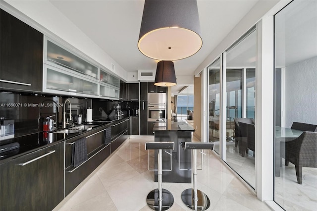 kitchen with a kitchen island, sink, and double oven