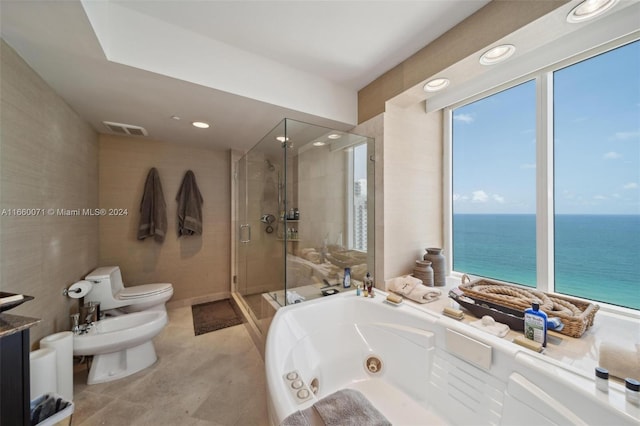 bathroom featuring toilet, a water view, tile patterned flooring, a bidet, and independent shower and bath