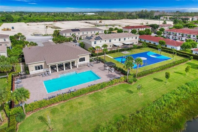 view of swimming pool with a lawn and a patio