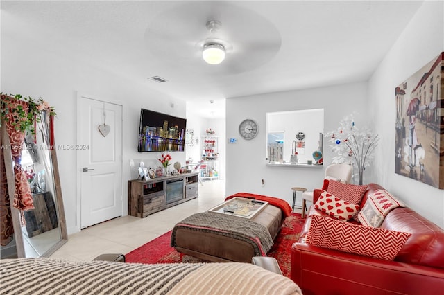 living room featuring light tile patterned floors and ceiling fan