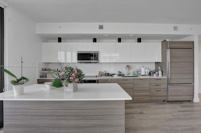 kitchen featuring sink and white cabinetry