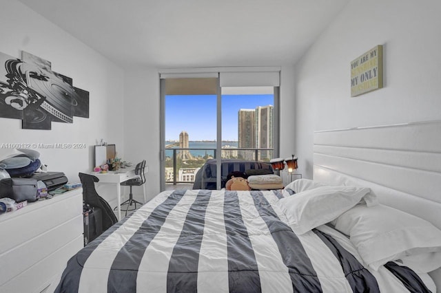 bedroom with a water view and access to exterior