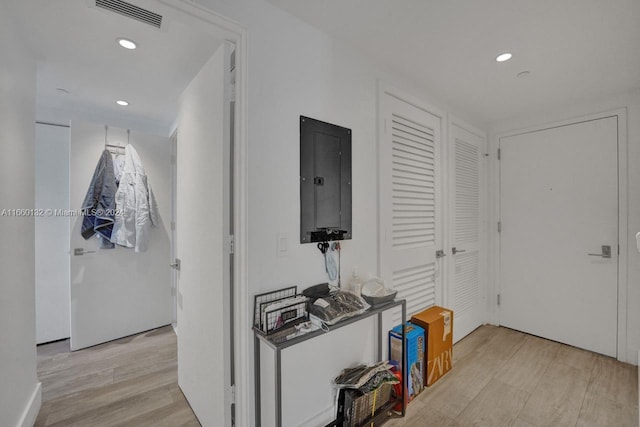 hallway with electric panel and light wood-type flooring