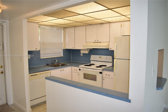 kitchen with a drop ceiling, white cabinetry, white appliances, light tile patterned floors, and sink